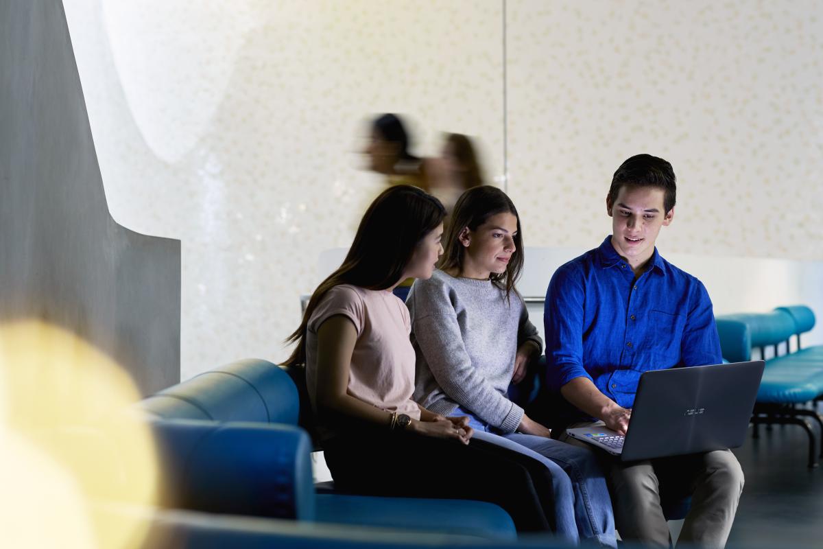 Students looking at laptop